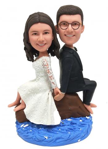 Custom wedding bobblehead sitting on beach